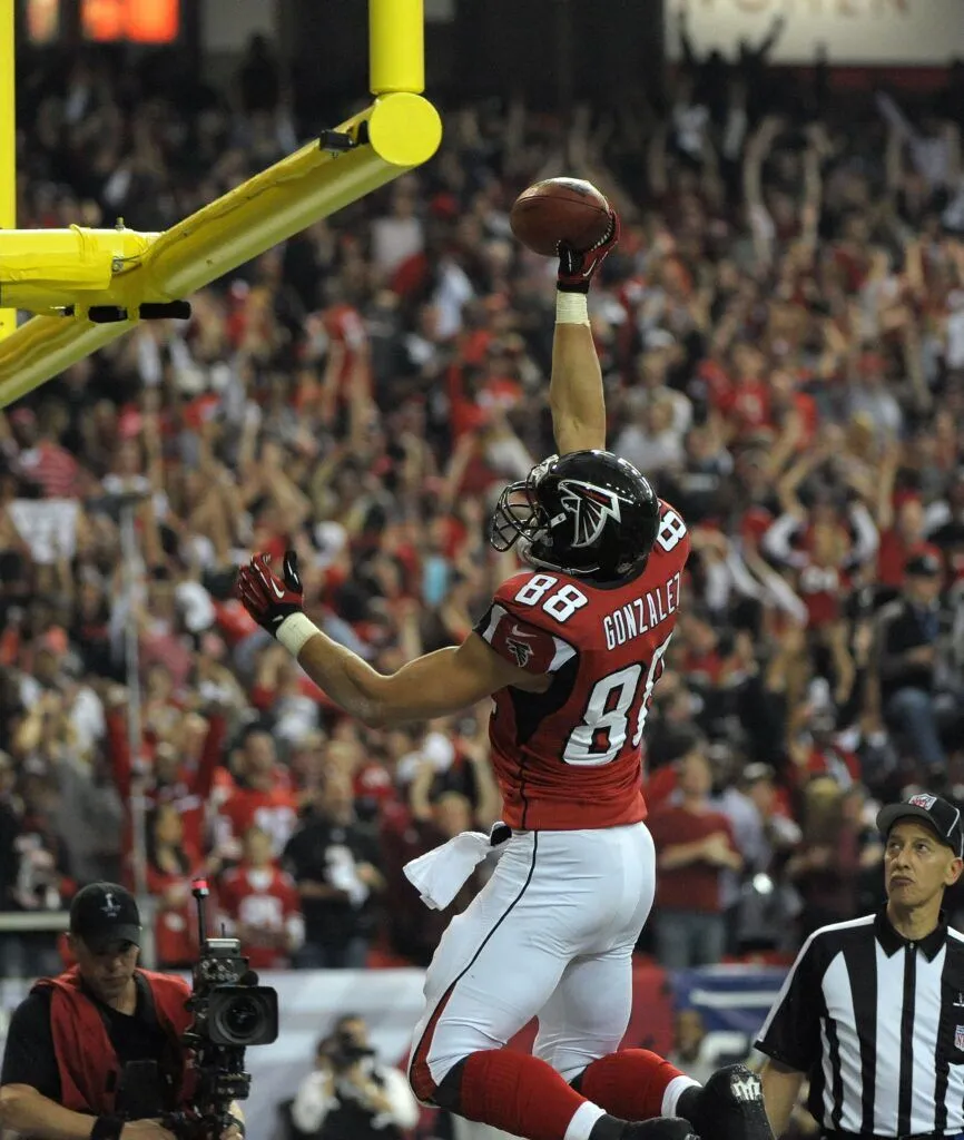 Atlanta Falcons tight end Tony Gonzalez celebrates his touchdown against the San Francisco 49ers by dunking the football over the goal post during the first half of the NFC Championship game at the Georgia Dome in Atlanta on January 20, 2013.