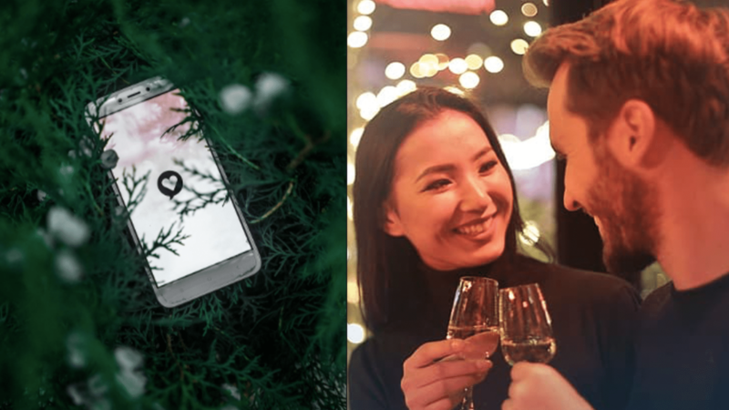 Smartphone with a heart notification icon in greenery next to a smiling couple clinking wine glasses in warm lighting