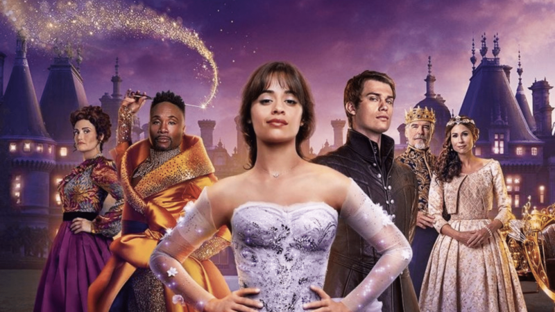 Camila Cabello as Cinderella with cast in royal costumes and magical sparkles against a castle backdrop