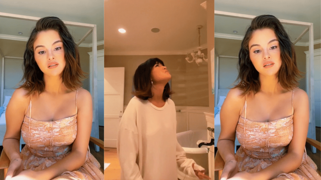 Selena Gomez in a floral dress sitting and a woman in a beige sweater looking up indoors.