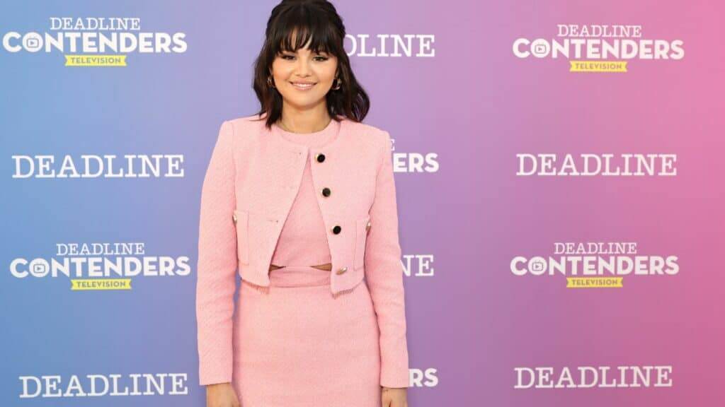 Selena Gomez smiling in a pink outfit at the Deadline Contenders Television event.
