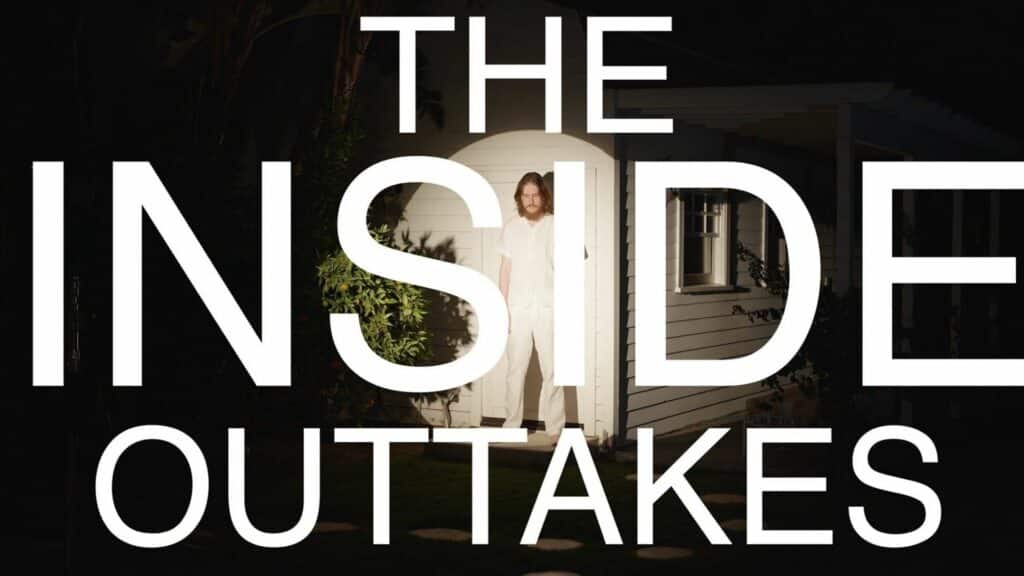 Man in white clothing standing outside a white house at night with "THE INSIDE OUTTAKES" text overlay
