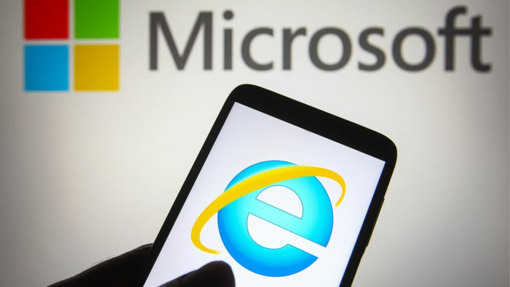 Internet Explorer logo displayed on a smartphone screen with Microsoft logo in the background.