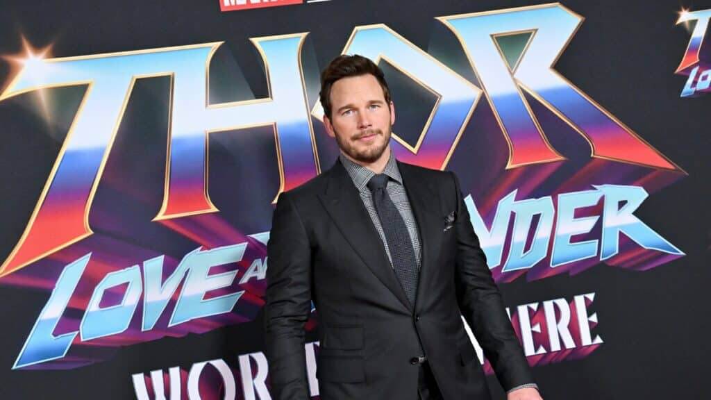 Chris Pratt in a black suit at the Thor: Love and Thunder world premiere backdrop