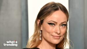Olivia Wilde with winged eyeliner and dangling earrings at a formal event