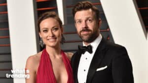 Olivia Wilde in a red dress and Jason Sudeikis in a black tuxedo posing at a formal event