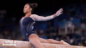 Female gymnast performing a split on the balance beam at the Tokyo 2020 Olympics