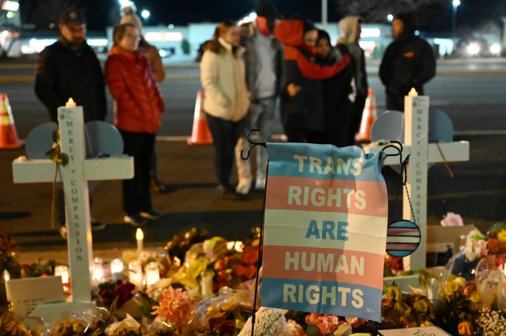 A flag reading "Trans Rights Are Human Rights" at a vigil outside Club Q.