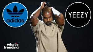 Kanye West holding a microphone with Adidas and Yeezy logos on a black background.