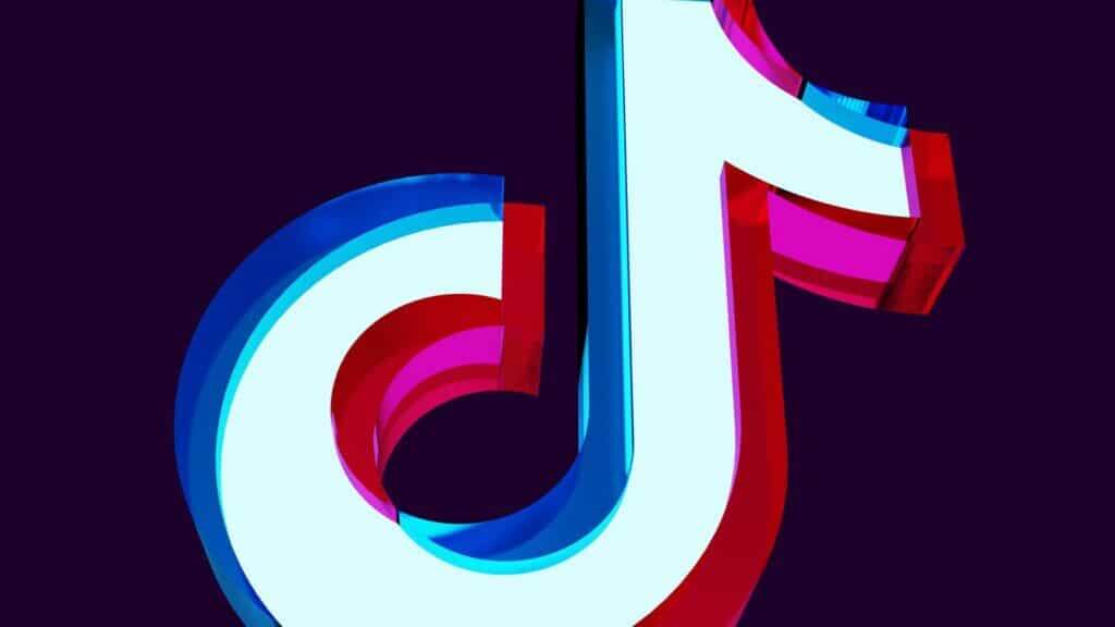 3D TikTok logo with blue, red, and pink colors on a dark background