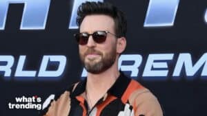 Chris Evans wearing sunglasses and a patterned shirt at a premiere event with "what's trending" logo.