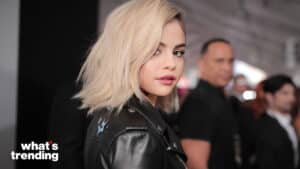 Selena Gomez with blonde hair wearing a black leather jacket at a public event