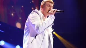 Nick Carter sings into a microphone