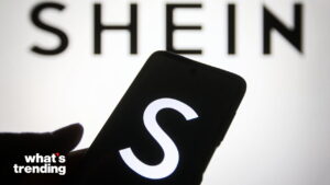 SHEIN logo displayed on a smartphone screen with the brand name in the background.