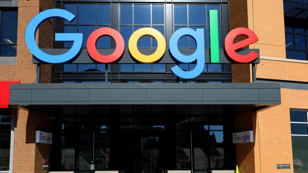 Google logo sign on a brick building facade above the entrance doors