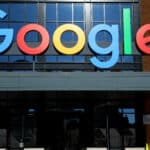 Google logo sign on a brick building facade above the entrance doors