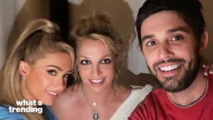 Paris Hilton, Britney Spears, and Sam Asghari smiling in a close-up selfie with "what's trending" text.