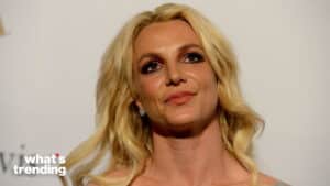 Britney Spears with blonde hair and makeup at a public event with "what's trending" logo.