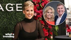 Woman with short blonde hair and black sheer top smiling in front of a floral wall, inset of a smiling couple in business attire