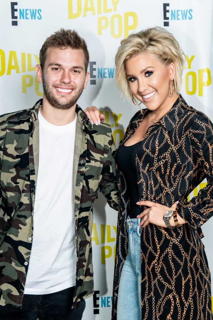 Savannah and Chase Chrisley pose for a photo in studio