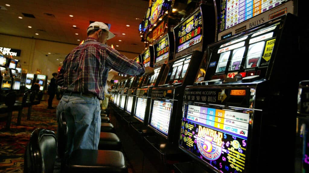 ATLANTIC CITY, NJ - JULY 1: A man plays slot machines July 1, 2003 in a Atlantic City, New Jersey casino. A new casino, the 43-story Borgata, will open Thursday in Atlantic City with hopes to draw a younger and more affluent crowd to a city that has become depressed due to the proliferation of riverboat gambling and Indian reservation casinos. The $1 Billion Borgata will feature 3,650 slot machines, 11 restaurants, a 50,000 square-foot spa and numerous retail shops.