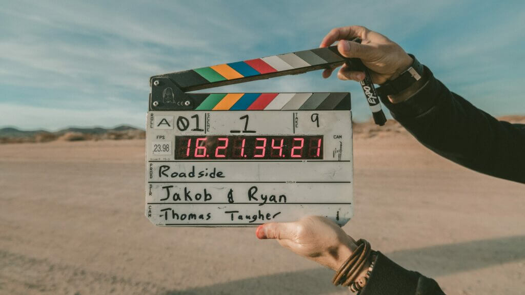 Film clapperboard for "Roadside" directed by Jakob & Ryan, held outdoors in a desert setting.