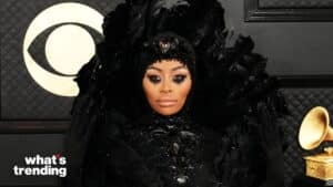 Blac Chyna wearing a black feathered and bejeweled outfit with dramatic eye makeup at a Grammy event
