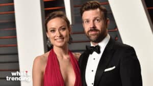 Olivia Wilde in a red dress and Jason Sudeikis in a black tuxedo posing at a formal event