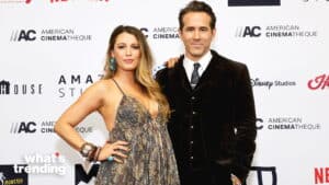 Blake Lively in a patterned dress and Ryan Reynolds in a black suit posing at an American Cinematheque event.