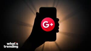 Hand holding smartphone displaying Google+ logo with "what's trending" text in corner