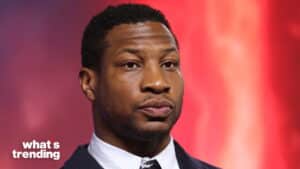 Close-up of a man in a suit with a red background and "what's trending" text in the corner