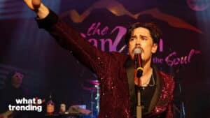Male singer in a red sequined jacket performing on stage with a microphone at The Canyon club