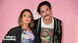 Two people posing against a pink background with "what's trending" text in the corner