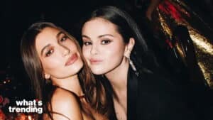 Hailey Bieber and Selena Gomez posing closely together at a nighttime event