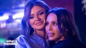 Two women embracing with emotional expressions under blue lighting with "what's trending" logo in corner