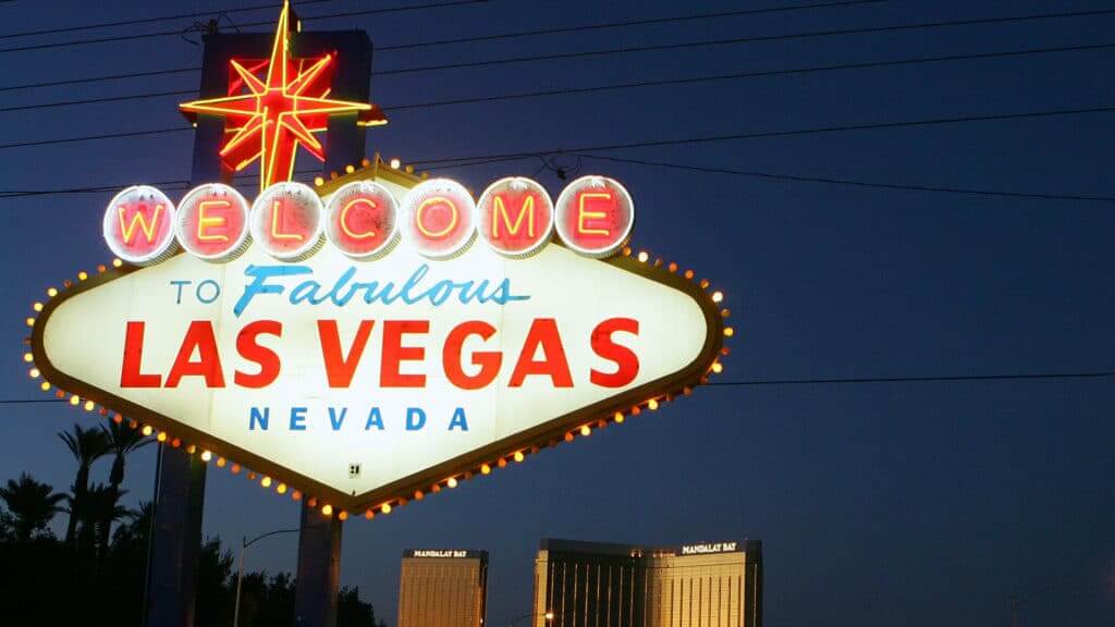 Welcome to Fabulous Las Vegas Nevada neon sign lit at night with Mandalay Bay hotel in background