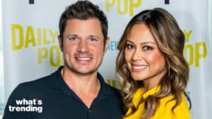 Nick Lachey and Vanessa Lachey smiling at a Daily Pop event backdrop