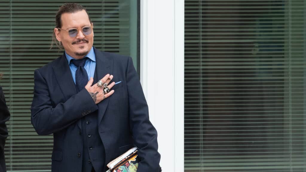 FAIRFAX, VA - MAY 27: (NY & NJ NEWSPAPERS OUT) Johnny Depp gestures to fans during a recess outside court during the Johnny Depp and Amber Heard civil trial at Fairfax County Circuit Court on May 27, 2022 in Fairfax, Virginia. Depp is seeking $50 million in alleged damages to his career over an op-ed Heard wrote in the Washington Post in 2018.(Photo by Cliff Owen/Consolidated News Pictures/Getty Images)