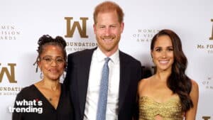 Prince Harry and Meghan Markle pose with a woman at the Women of Vision Awards event.