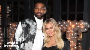 Tristan Thompson and Khloé Kardashian posing together at an event with balloon decorations in the background
