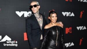 Travis Barker in spiked blazer and Kourtney Kardashian in black leather dress at MTV VMAs red carpet