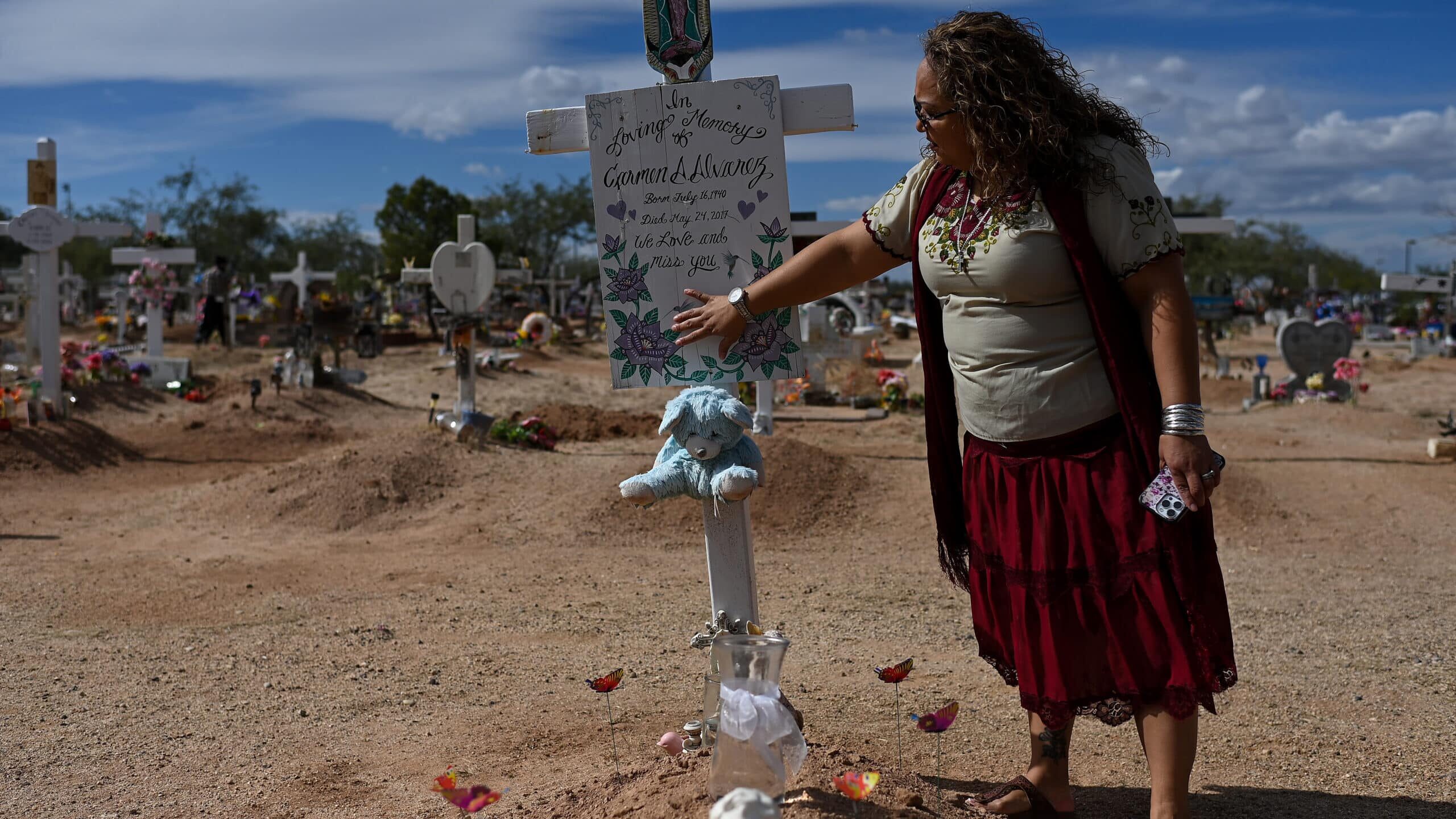 TUCSON, AZ - NOVEMBER 1: Yaqui Indian Native American Rosa Alvarez touches the grave of her foster mother Carmen Alvarez at Monte Calvario Cemetery during All Souls Day on November 1, 2022 in Tucson, Arizona. The U.S. Supreme Court will hear arguments about the Indian Child Welfare Act on November 9th. ICWA, which was passed by Congress in 1978, helps keep Native American children close to their families and traditional heritage.