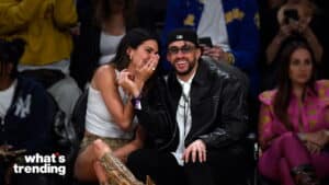 Kendall Jenner whispering to Bad Bunny at a public event with "what's trending" text in the corner.