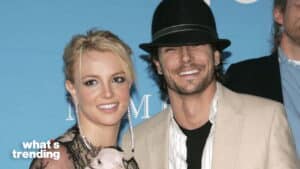 Britney Spears and Kevin Federline smiling at a public event with a small dog.