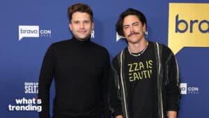 Two men posing at BravoCon 2022 with a blue backdrop featuring Bravo and Bud Light Seltzer logos