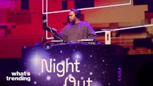 DJ performing at a Night Out event with a starry-themed DJ booth and red background lighting