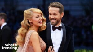 Blake Lively and Ryan Reynolds smiling together on a red carpet event.