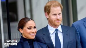 Prince Harry and Meghan Markle smiling together outdoors in formal attire