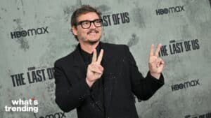 Pedro Pascal wearing black suit and glasses making peace signs at The Last of Us HBO Max event