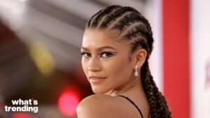 Zendaya with braided hair and winged eyeliner looking over her shoulder at an event with "what's trending" logo.